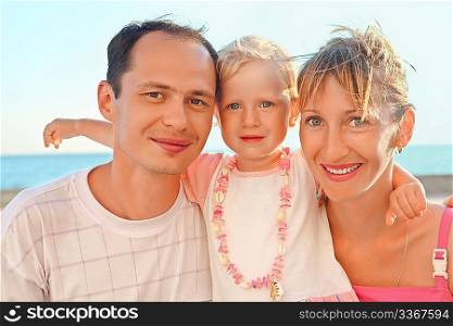 Happy family with little near to sea