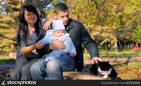 Happy family with pet resting outdoor