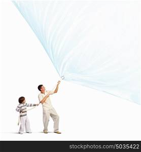 Happy family. Young happy family pulling blank banner. Place for text