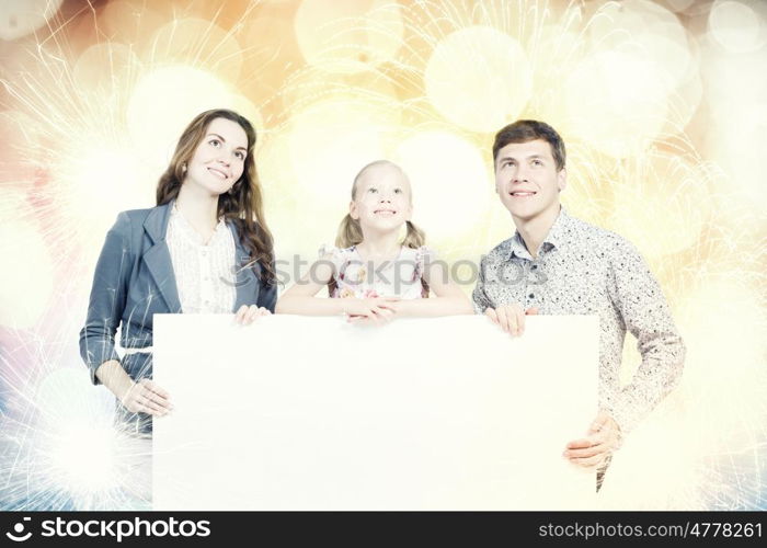 Happy family. Young happy family with white blank banner. Place for text