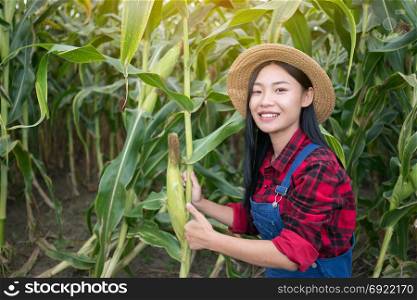Happy farmer posing in the corn field