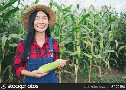 Happy farmer posing in the corn field