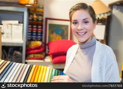 happy fashion designer in her studio