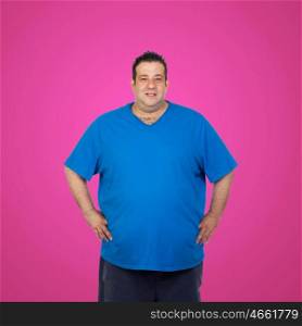 Happy fat man with blue shirt and a pink background