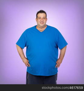 Happy fat man with blue shirt and a purple background