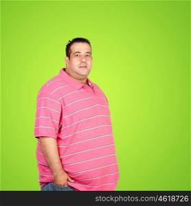Happy fat man with pink shirt and a green background