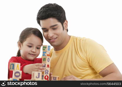 Happy father and daughter playing block game