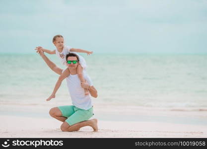 Happy father and his adorable little daughter enjoy summer vacation. Happy father and his adorable little daughter at tropical beach having fun