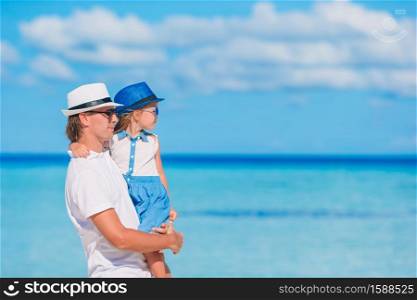 Happy father and little girl on the beach. Little girl and happy dad having fun during beach vacation