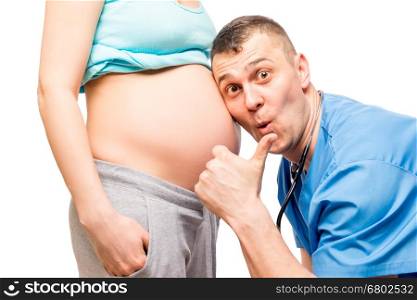 happy father and the doctor listening the baby in wife's stomach