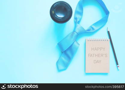 Happy Father's Day concept with blue colour necktie and coffee cup on pastel background