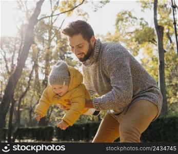 happy father with baby outdoors