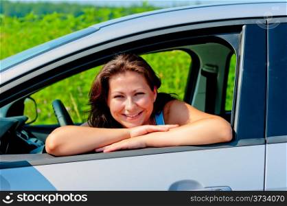 Happy female driver in her new car