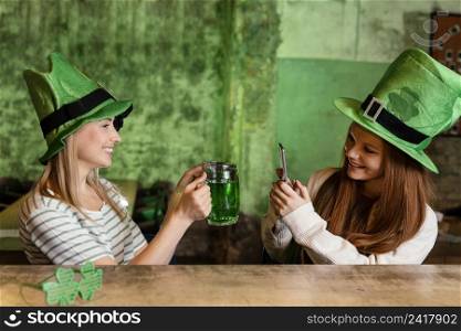 happy female friends celebrating st patrick s day together bar with drink