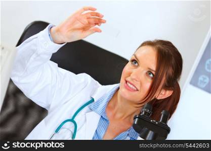 Happy female medical doctor working with sample&#xA;