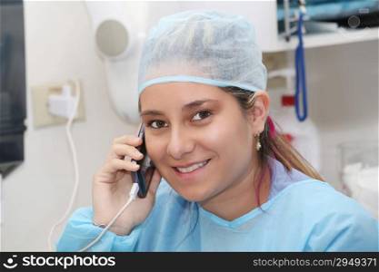 happy female surgeon using mobile phone