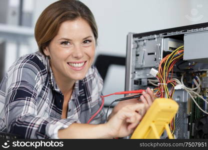 happy female technician repairing a computer