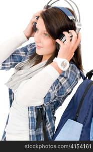 Happy female teenager enjoy music with headphones and baseball cap