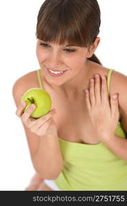 Happy female teenager with green healthy apple