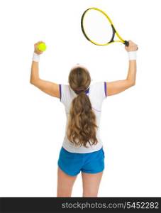Happy female tennis player rejoicing success. rear view