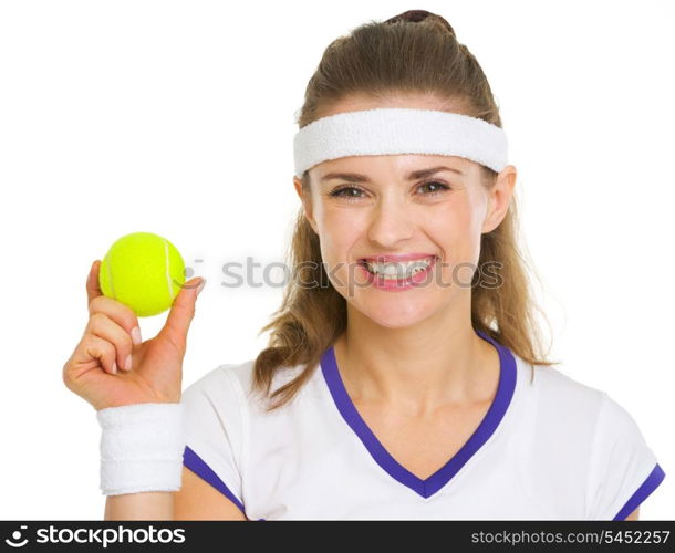 Happy female tennis player showing tennis ball