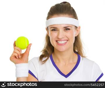 Happy female tennis player showing tennis ball