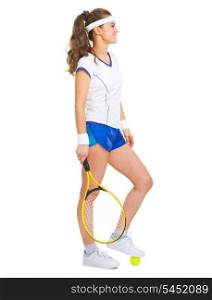 Happy female tennis player with racket and ball looking on copy space