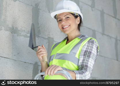 happy female worker puts plaster on a spatula