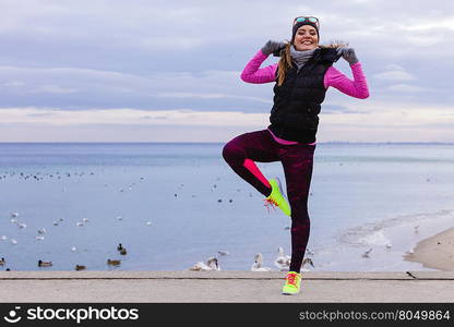 Happy fit fitness woman outdoor.. Sports and activities. Slim fit fitness woman outdoor. Athlete happy smiling girl training wearing warm sporty clothes outside in cold weather.