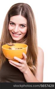 Happy fit woman eating cereals with milk bowl