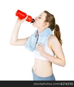 Happy fit young woman drinking from water bottle after workout