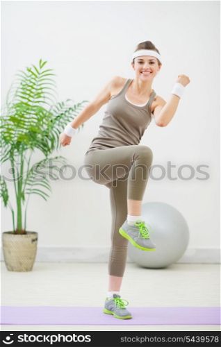 Happy fitness woman making gymnastics