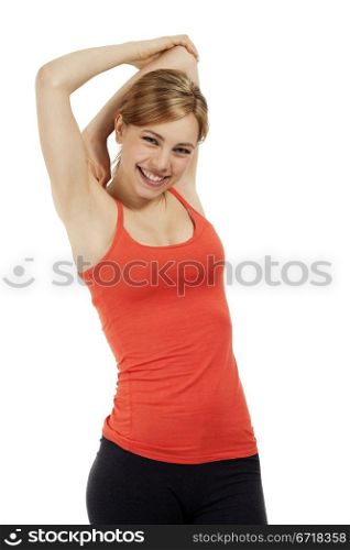 happy fitness woman stretching her arms. young happy fitness woman in red shirt stretching her arms on white background