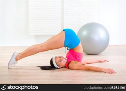 Happy fitness young girl working out at living room&#xA;