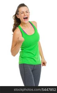 Happy fitness young woman making fist pump gesture