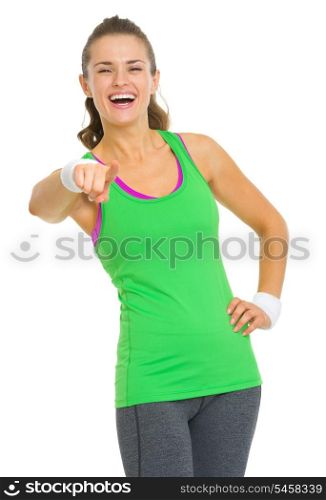Happy fitness young woman pointing in camera