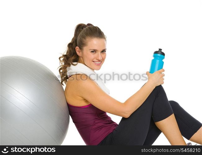 Happy fitness young woman relaxing after workout on fitness ball