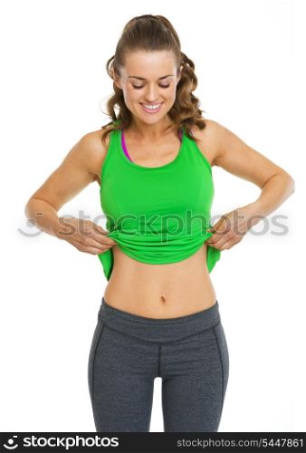 Happy fitness young woman showing belly