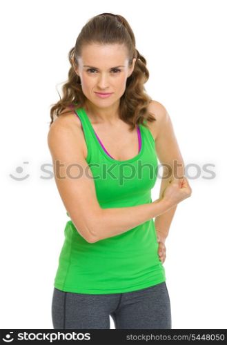 Happy fitness young woman showing biceps