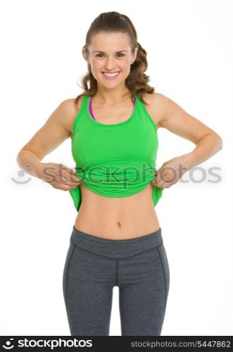 Happy fitness young woman showing flat belly
