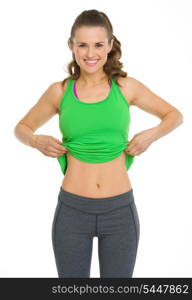 Happy fitness young woman showing flat belly