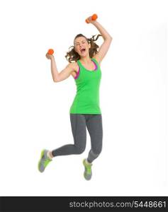 Happy fitness young woman with dumbbells jumping