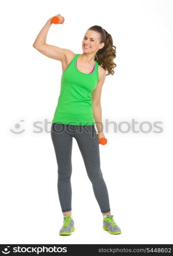Happy fitness young woman with dumbbells showing biceps