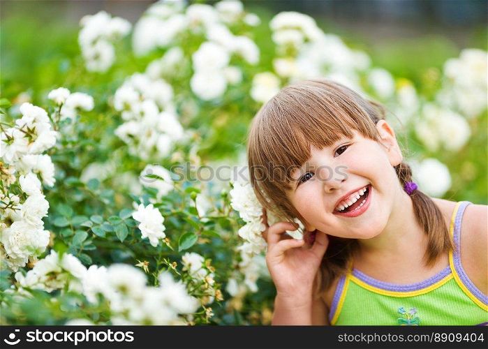 Happy five years Girl smiling outdoors headshot. Flower Girl smiling