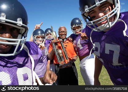 Happy Football Coach with Trophy and Players