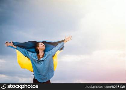 Happy free ukrainian woman with national flag on dramatic sky background. Portrait of lady in blue embroidery vyshyvanka shirt. Copy space. Ukraine, independence, patriot symbol. High quality photo. Happy free ukrainian woman with national flag on dramatic sky background. Portrait of lady in blue embroidery vyshyvanka shirt. Copy space. Ukraine, independence, patriot symbol