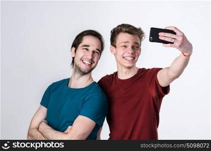 Happy friends are taking selfie. Two happy friends taking selfie on mobile phone camera
