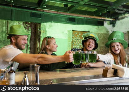 happy friends celebrating st patrick s day together with drink bar