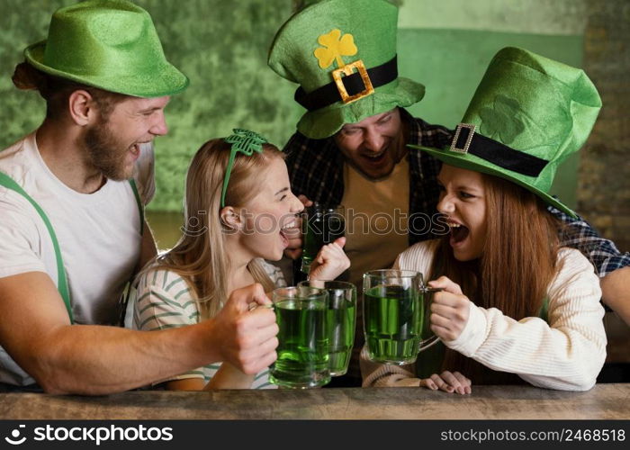 happy friends celebrating together st patrick s day with drinks bar