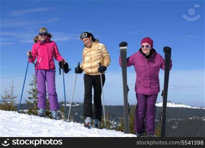 happy friends group of woman girls have fun at winter season at beautiful sunny snow day with blue sky in background